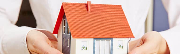 Model of a house with pitched, shingled roof